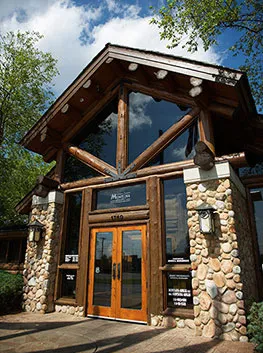Montana Grille log cabin entrance with stone columns