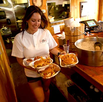 Server carrying Lunch Pail burger baskets